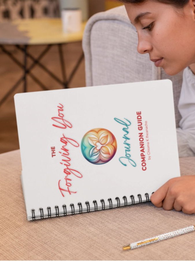The Forgiving You Journal Companion Guide, propped open on a sofa
